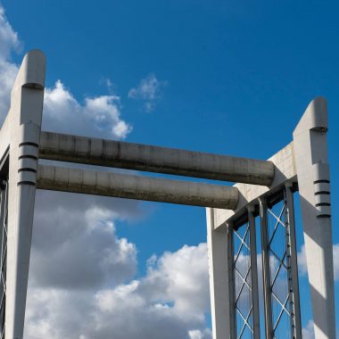A close-up view of a modern bridge structure under a blue sky in Dordrecht, Netherlands.